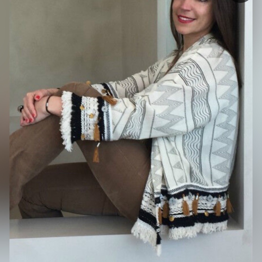 Riva - cardigan/jacket accessorized with tassels, beads and medallions.